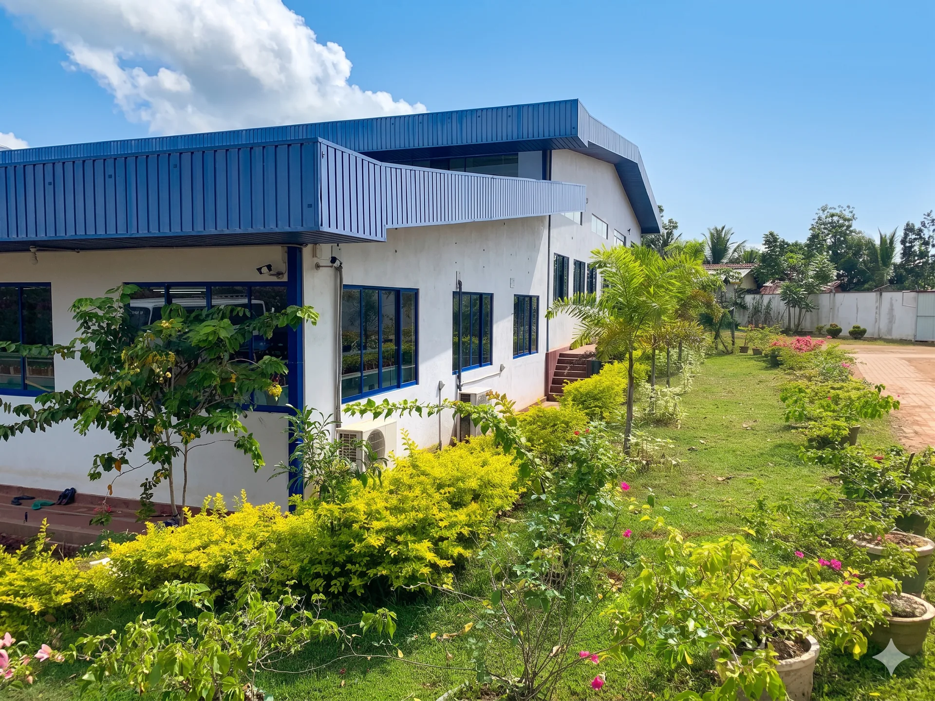 Side exterior and landscaped grounds of the Dewmini Apparel factory